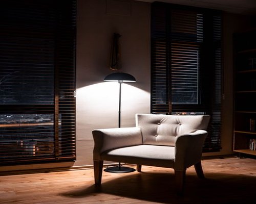 A cozy reading corner with a warm lamp in the evening