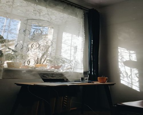 A desk setup positioned next to a window with soft morning sunlight